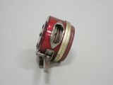 a close up of a fishing reel on a white surface