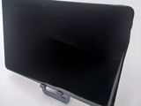 a black tablet computer sitting on top of a white table