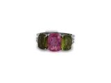 a close up of a pink and green ring on a white background