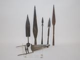 four different types of knives on display on a white surface