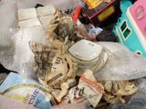 a pile of trash that is sitting in a trash can