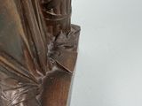 a bronze statue of a woman holding a umbrella