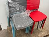 several plastic chairs are stacked on a pallet in a warehouse