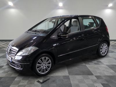 a picture of a black mercedes b - class parked in a showroom