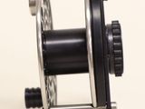 a close up of a reel on a white surface
