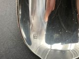a silver spoon with a handle that has a spoon in it