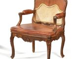 chair made of wood and leather with cane back and arms