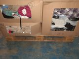 a cardboard box with clothes on top of it on a pallet