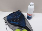 two tennis balls in a mesh bag next to a bottle of water