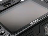 a close up view of a digital camera on a white surface