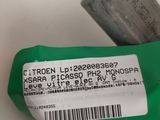 a close up of a green and white label on a piece of metal