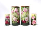 four vases with flowers painted on them on a white background