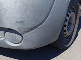 a close up of a white truck parked on the side of the road