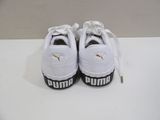 white puma sneakers with black and white logo on the sole