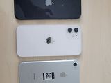 three iphones sitting on a table next to each other