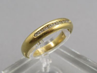 a close up of a gold ring with diamonds on it
