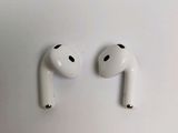two airpods sitting on top of a white surface