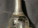 a glass decanter sitting on top of a silver tray