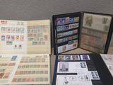 a lot of stamps on a table with a book open