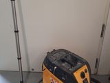 a vacuum that is sitting on the floor next to a pole