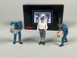 three figurines of men in blue uniforms are standing in front of a television