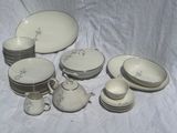 a lot of dishes and cups that are on a table