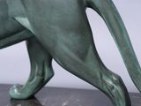 statue of a cat on a marble base with a white background