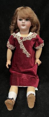 a small doll that is sitting on a black surface