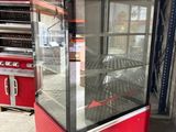 a large display case with a glass door in the middle of the room