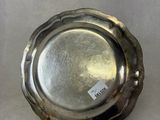 a silver plate on a table with a tag on it