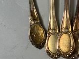 five spoons that are sitting next to each other on a table