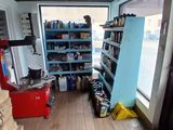 a view of a room with a refrigerator and shelves in it