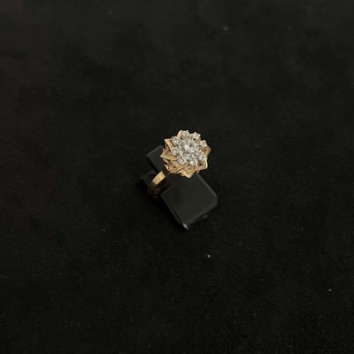 a picture of a diamond ring on a black surface