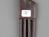 a wooden comb with a tag on it on a gray surface