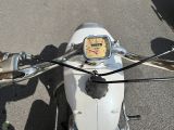 a close up of a motorcycle with a clock on the handlebars