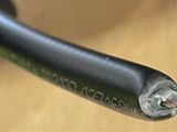 a close up of a black handle on a wooden table