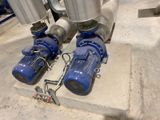 two blue pumps on the ground next to each other
