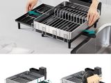 a woman is putting a dish rack into a sink