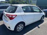 the back of a white toyota yaris parked in a parking lot