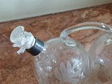 two empty wine bottles sitting on the floor next to each other