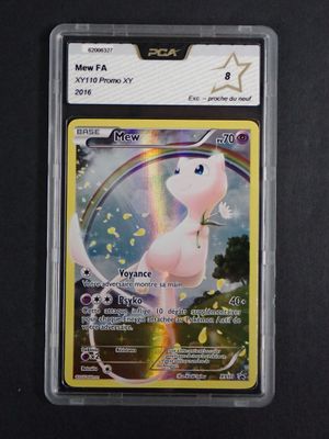 a close up of a pokemon card with a rainbow in the background