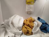 a pile of clothes sitting on a counter in a bathroom