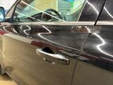 a car door handle with a sticker on it
