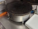 stainless steel counter top with plates and pans on top of it