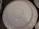 a white plate with a gold rim sitting on a table