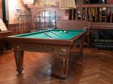 a pool table in the middle of a living room