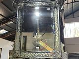 a large mirror hanging from the ceiling in a room