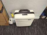 a piece of luggage sitting on the floor next to a wall