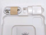 a white box with a charger and a cord attached to it