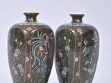 two vases sitting side by side on a white surface